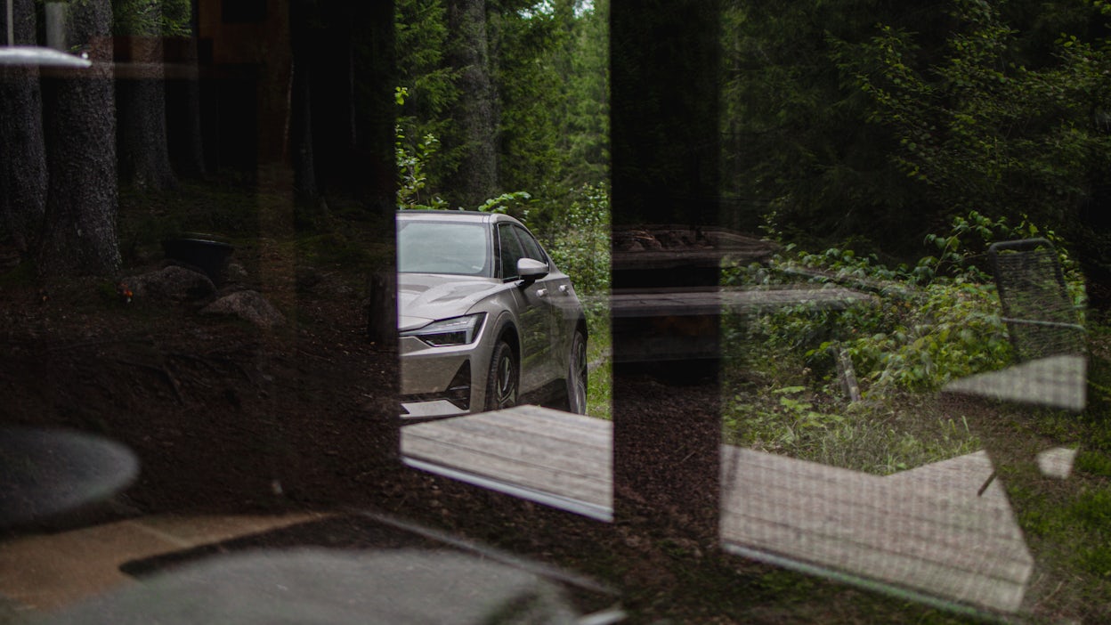 Polestar 2 visible through a cabin window.