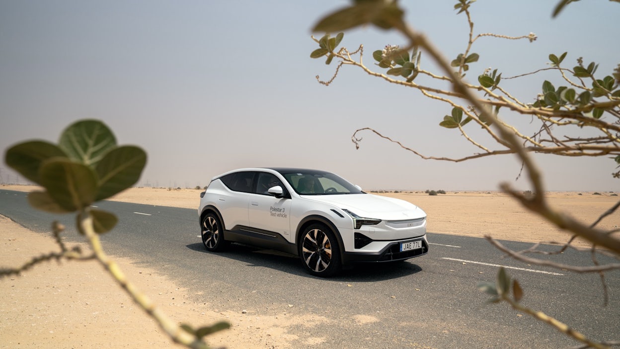 Side view of Polestar 3 framed by desert bush