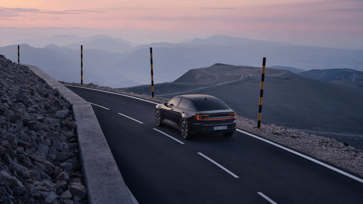Polestar 2 Long range Dual motor in Space with Performance Pack driving in the sunset.