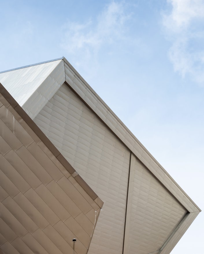 Worm's-eye view of wooden building and clear blue sky.