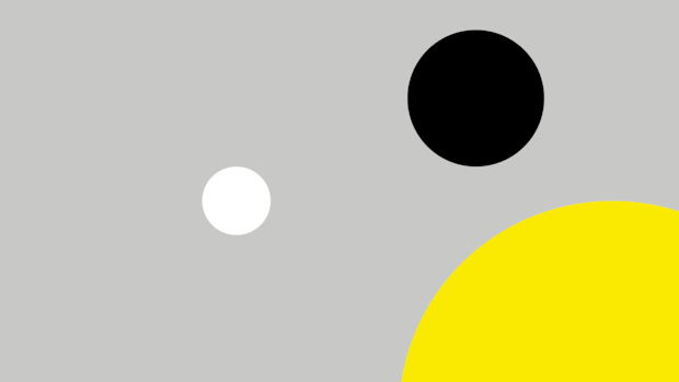 Grey background with one white, one black and one yellow circle.