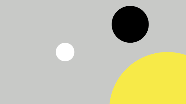 Grey background with one white, one black and one yellow circle.