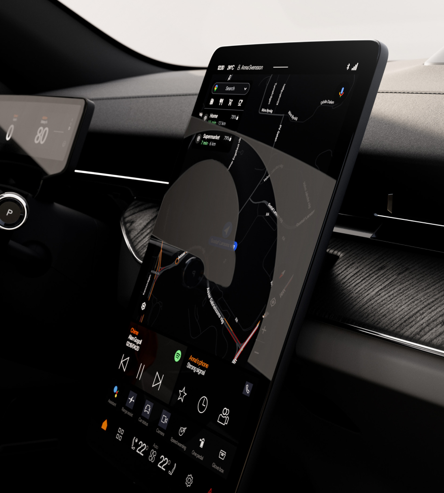 Steering wheel in the background, centre display in the foreground with Google Maps open, still clearly visible at an angle.