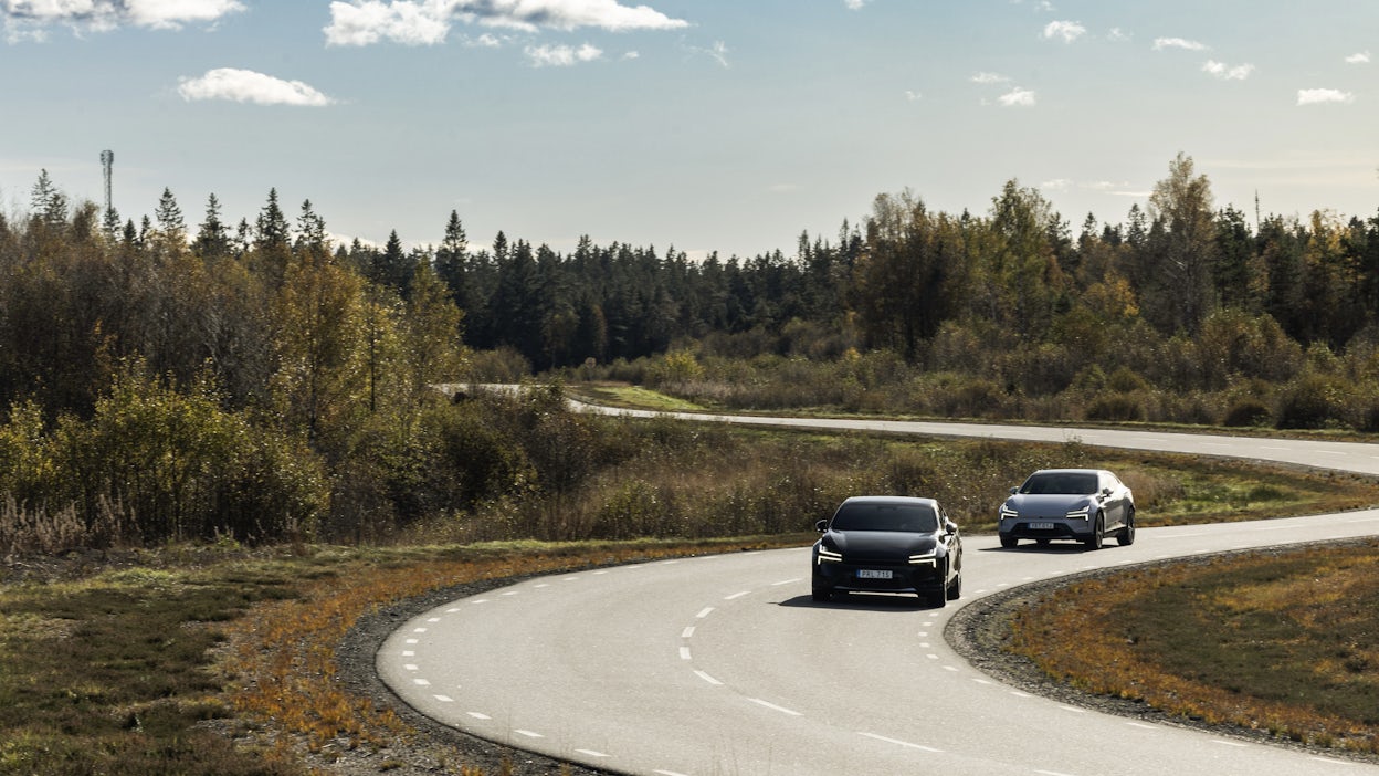 Two polestar 4s drive down winding country road