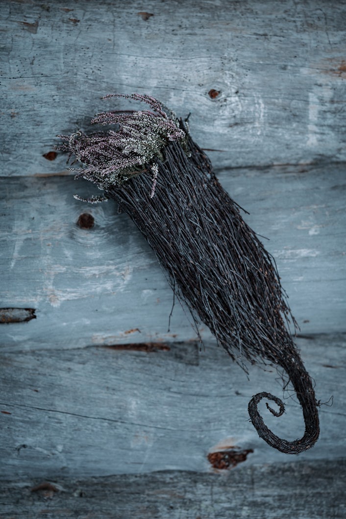 Dried heathers hanging on a house.