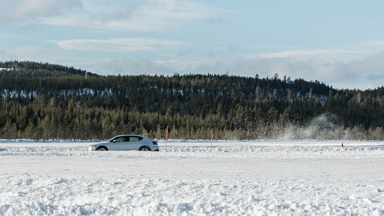 A Polestar 2 driving on the ice tracks in Jokkmokk.