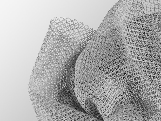 A white net shaped material on a white background.