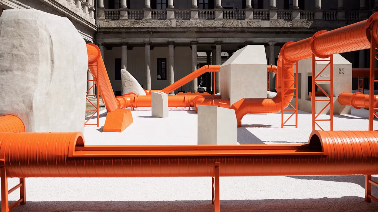 Large industrial orange pipes in old courtyard