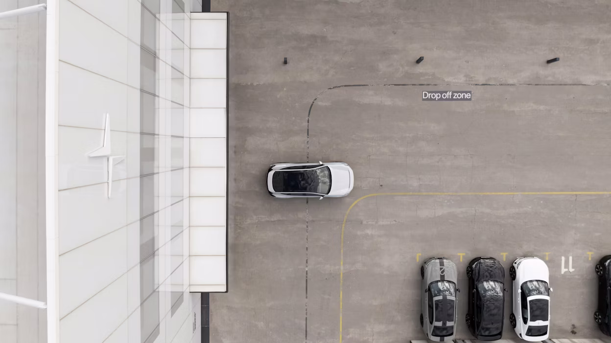 Polestar car parked in drop-off zone near building with Polestar logo, adjacent to other parked cars.