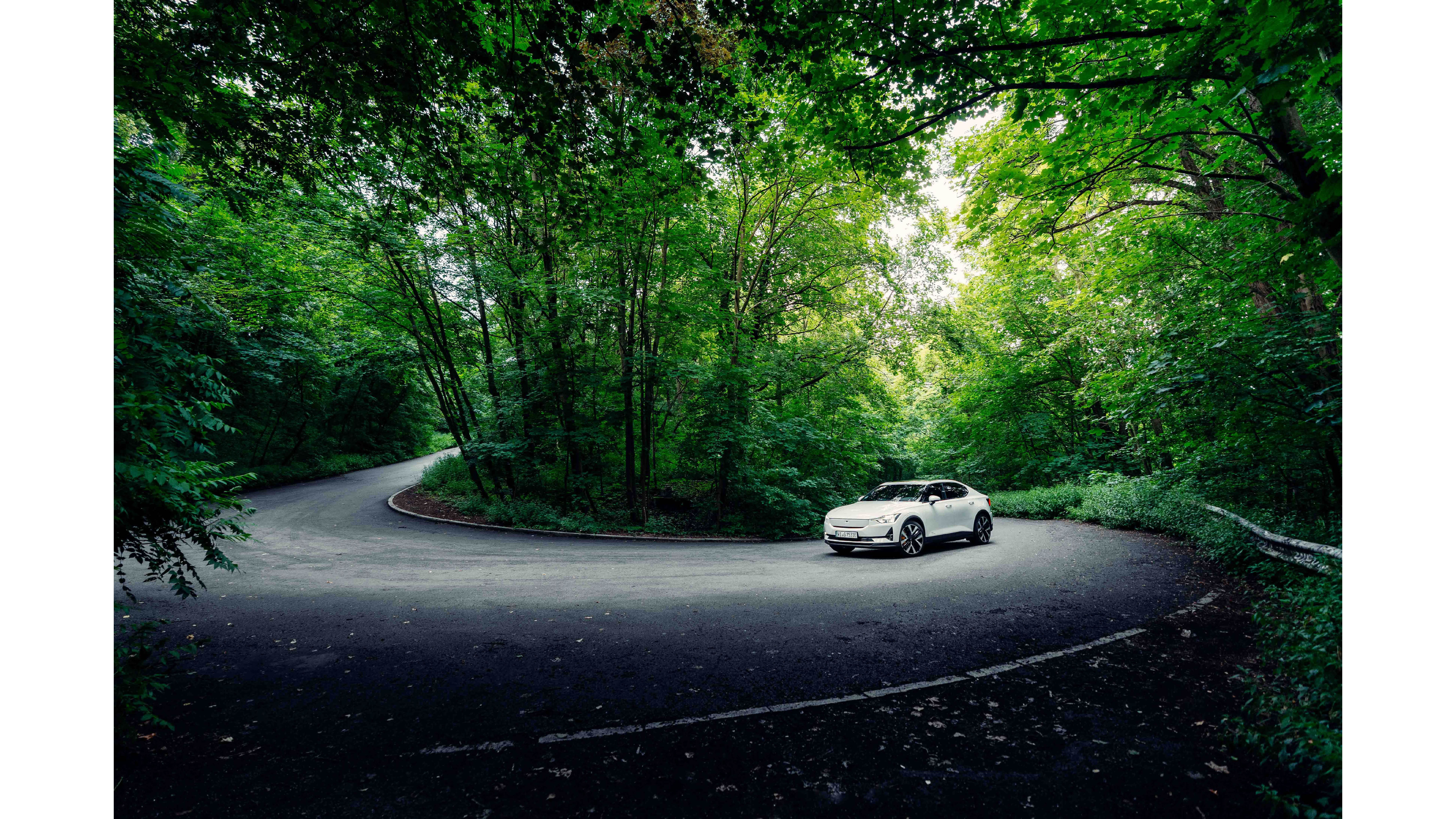 Polestar 2 driving up the forest in berlin