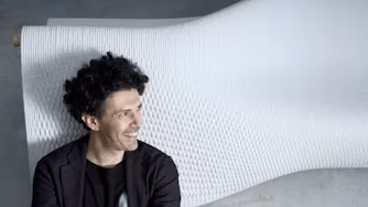 Man standing in front of sculpture