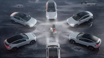 Six white Polestar cars arranged in a circular formation on icy ground with a central ice sculpture.
