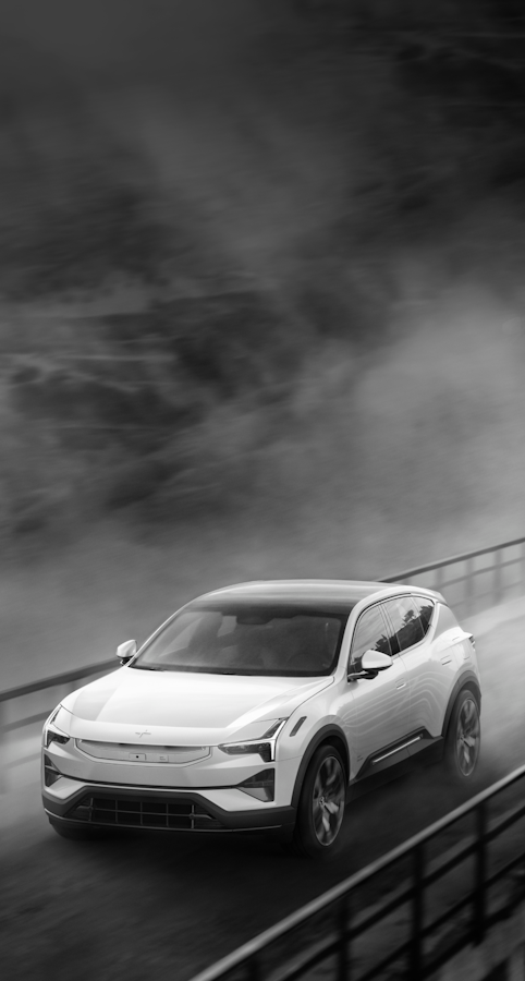 White Polestar 3 driving on a bridge dark misty skies above
