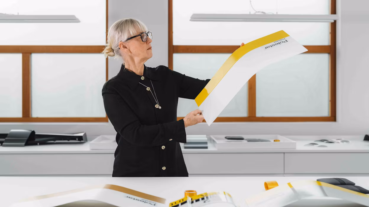 A designer looking at a colour selection on a sheet of paper