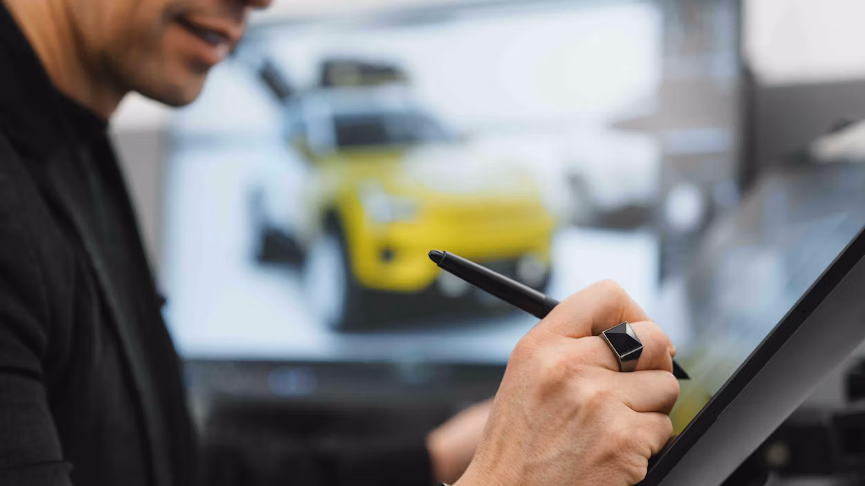 A designer drawing on a digital screen