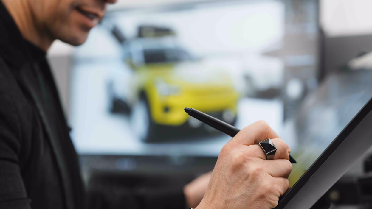 A designer drawing on a digital screen