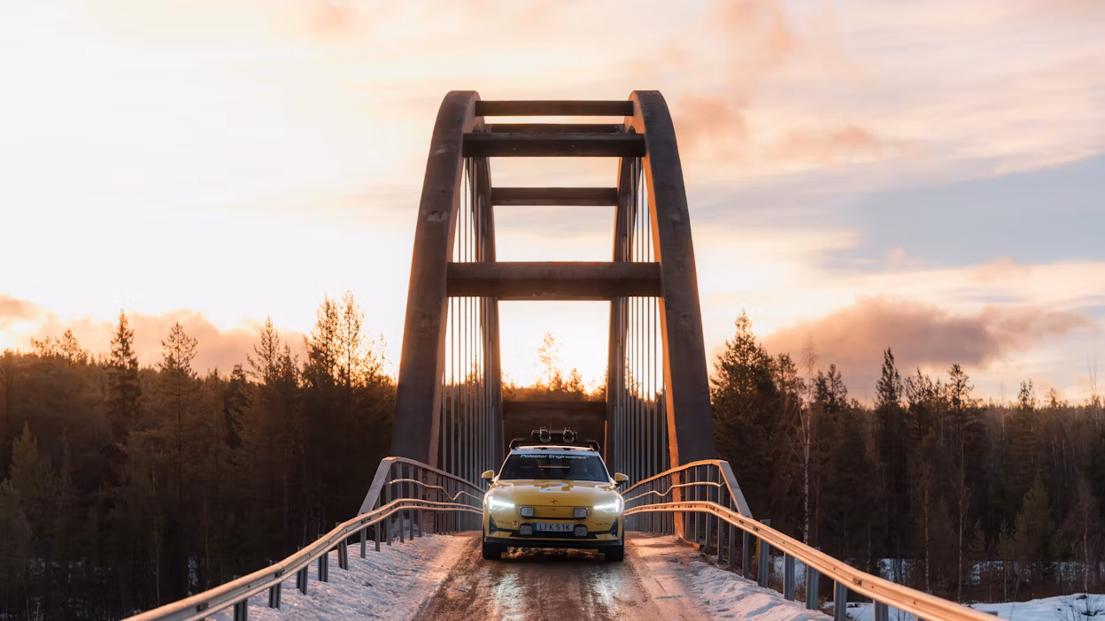 A car parked on a bridge in a forest