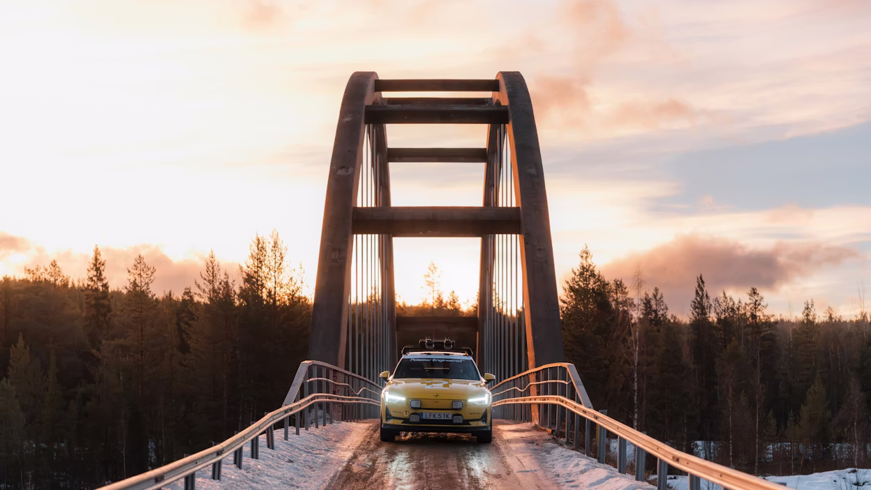 A car parked on a bridge in a forest