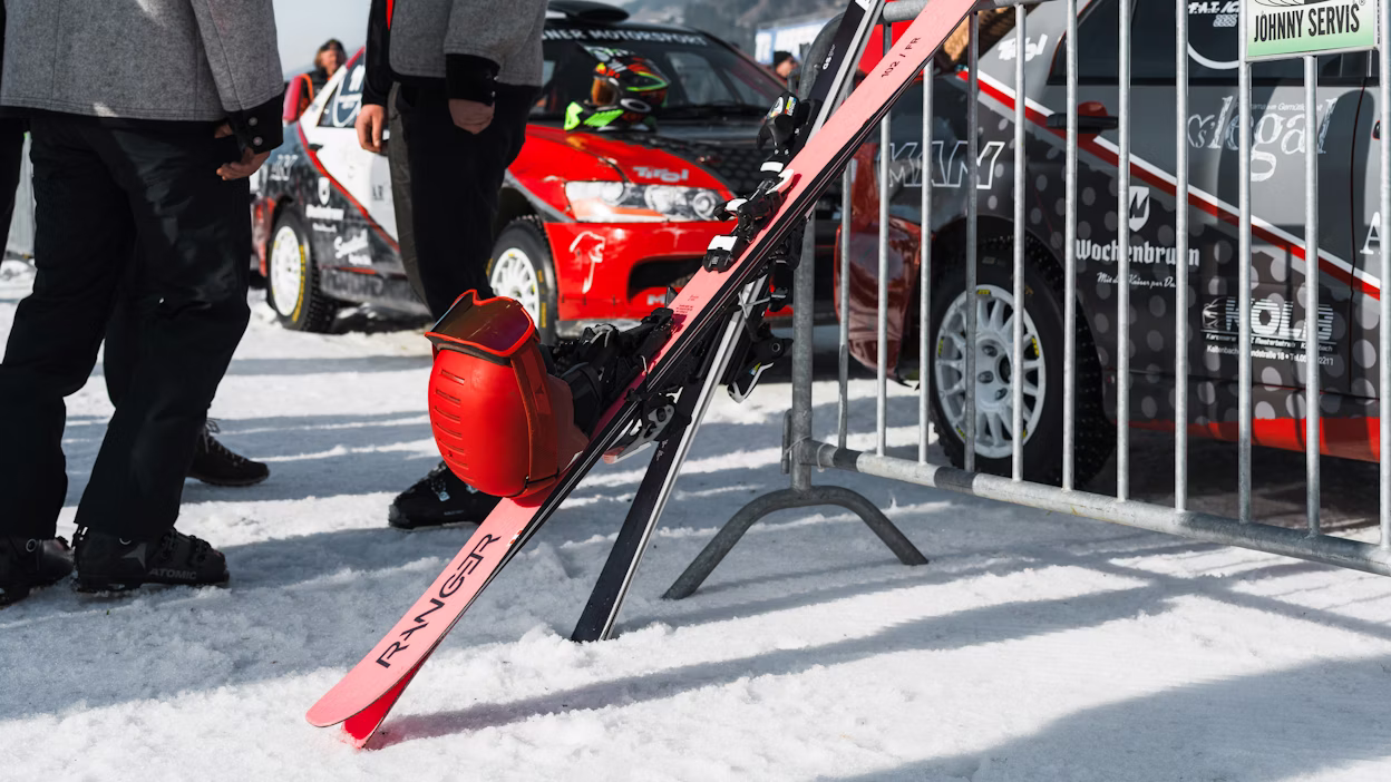 Skiing equipment in front of race cars