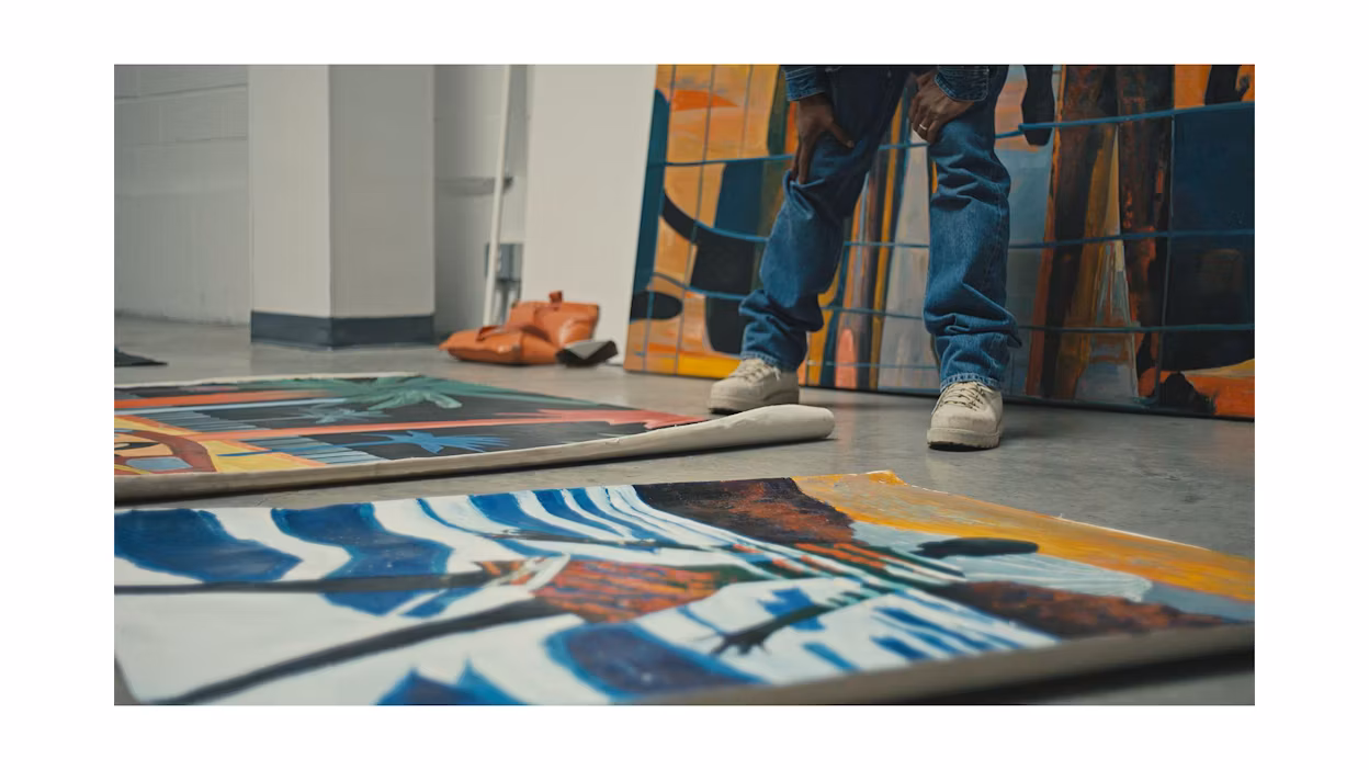 Jordan "Watts" Watson working on art in his studio.