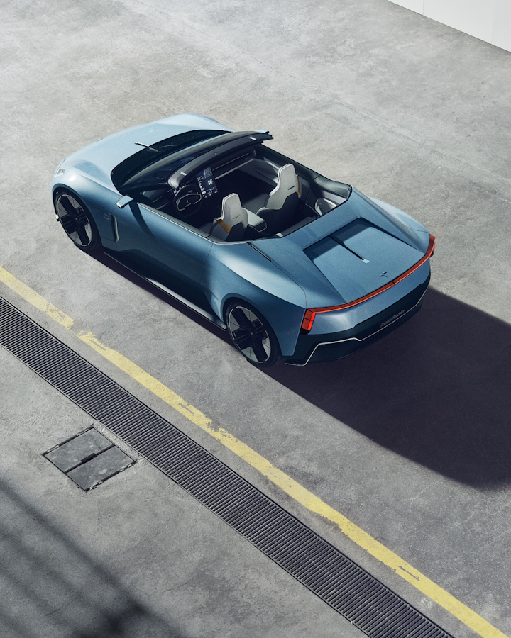 An angled downward view of Polestar 6 on an industrial concrete floor with a yellow line.