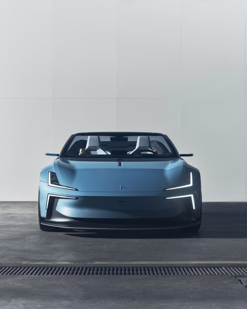 Front view of a Polestar car in a garage setting with white wall background.