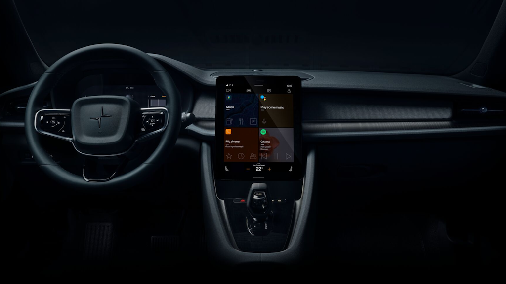 Interior of a Polestar 2 with steering wheel on the left and lit up infotainment in the middle showing the apps Google Maps, Voice assistant, Phone and Spotify