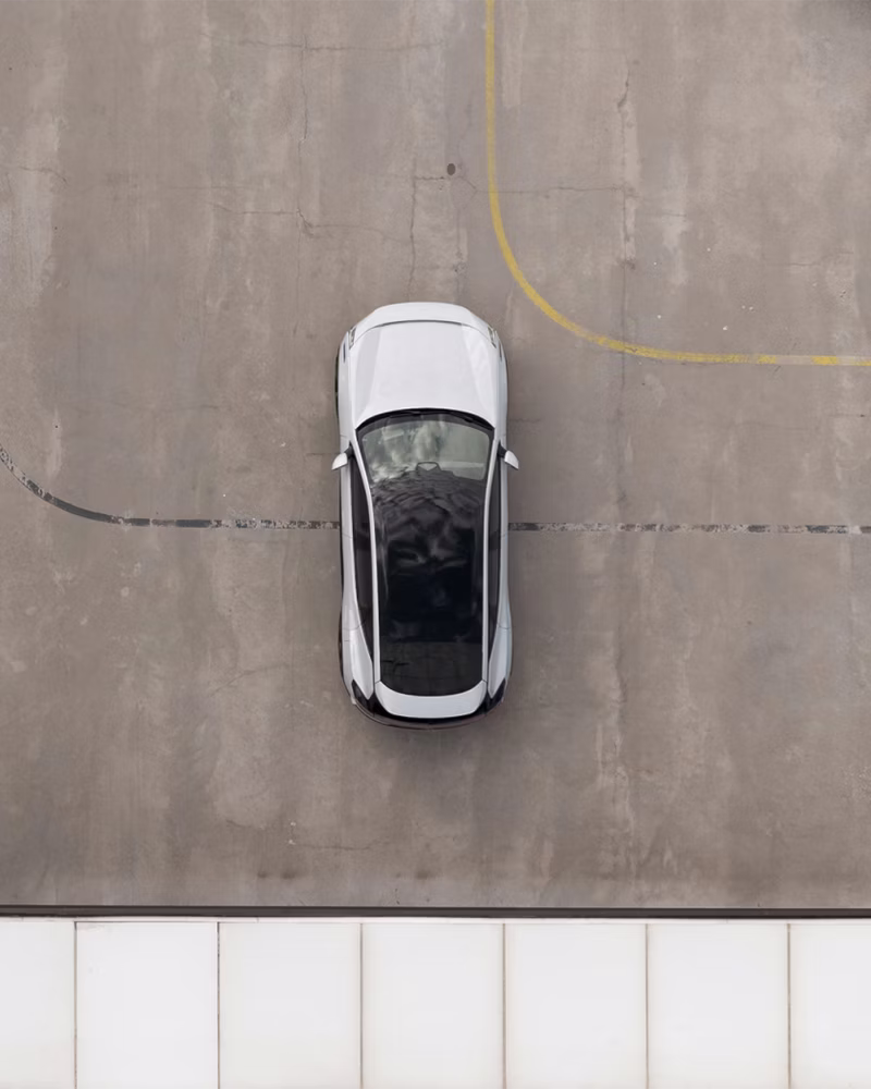 Polestar car parked on concrete surface with yellow and black lines visible.