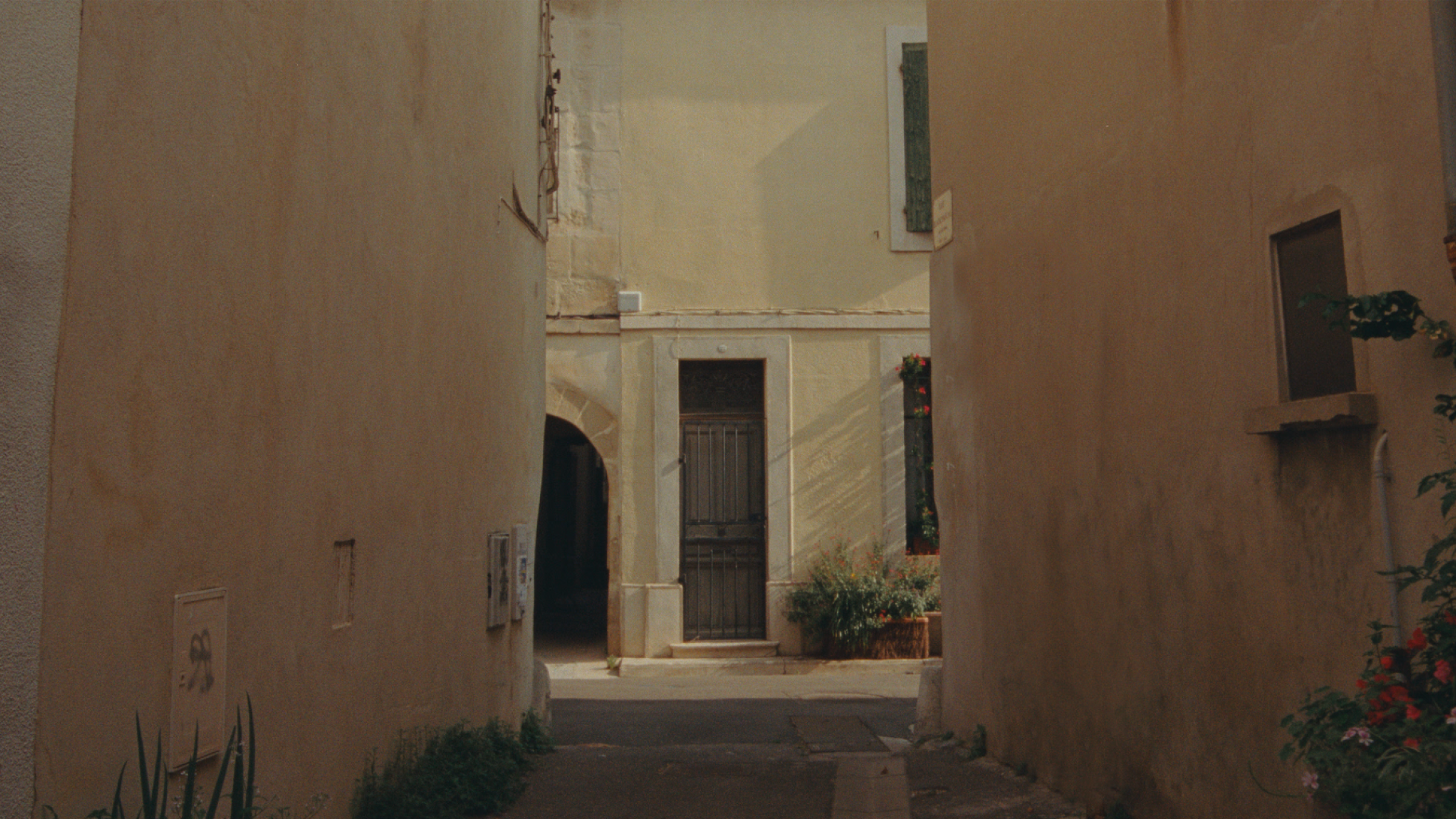 Polestar 2 driven through narrow streets and on a motorway by the side of a mountain.