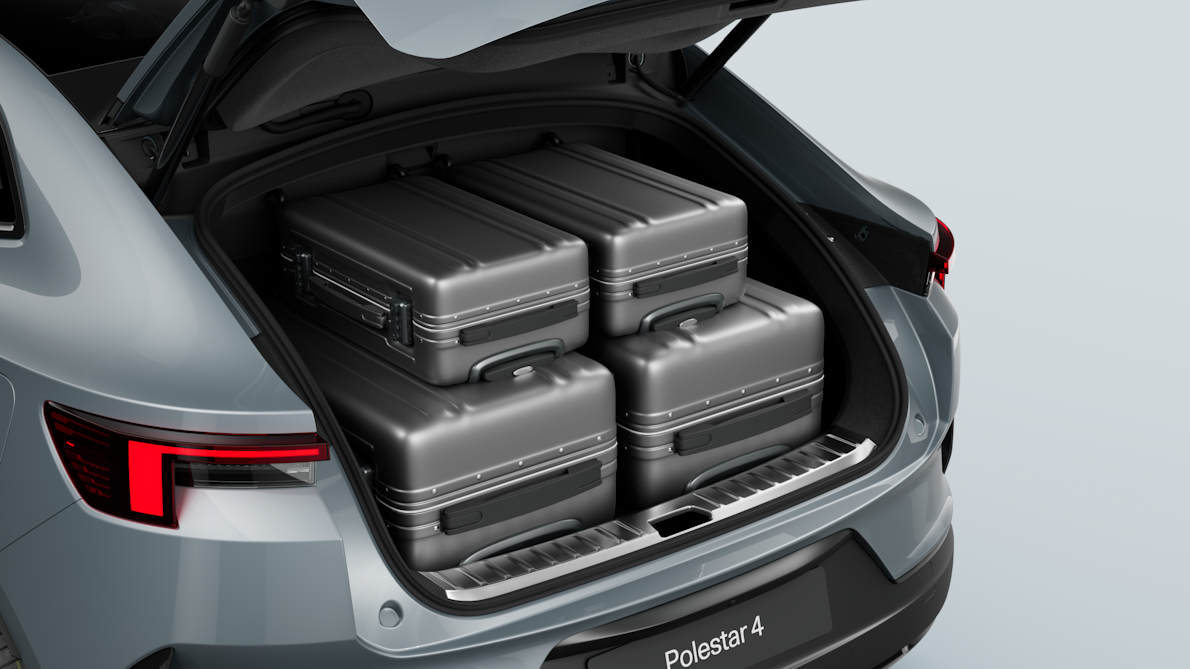 Polestar 4’s rear luggage compartment with two full-sized suitcases and carry-on sized suitcases.