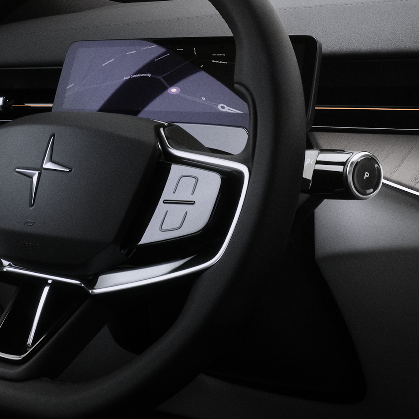 A close up of Polestar 3’s steering wheel with Polestar logo, indicator stalk, and buttons.