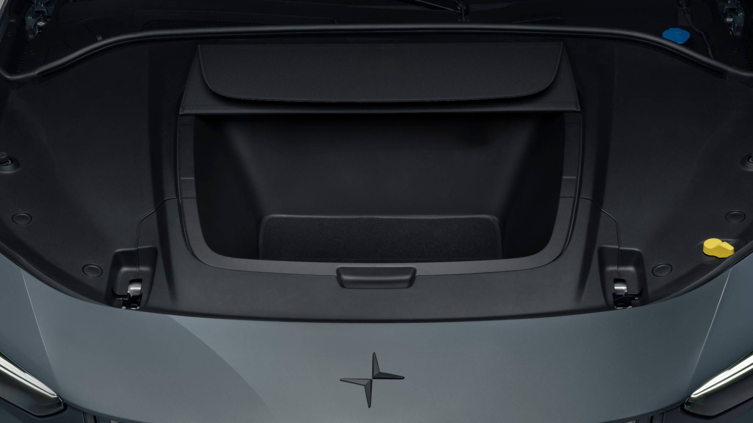 Polestar 3’s hood open showing the front storage compartment behind the Polestar logo.