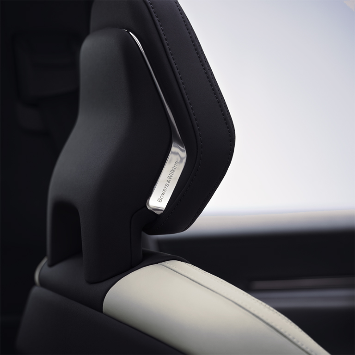 A close up view of Polestar 3’s front seat headrest with the Bowers & Wilkins metal logo.