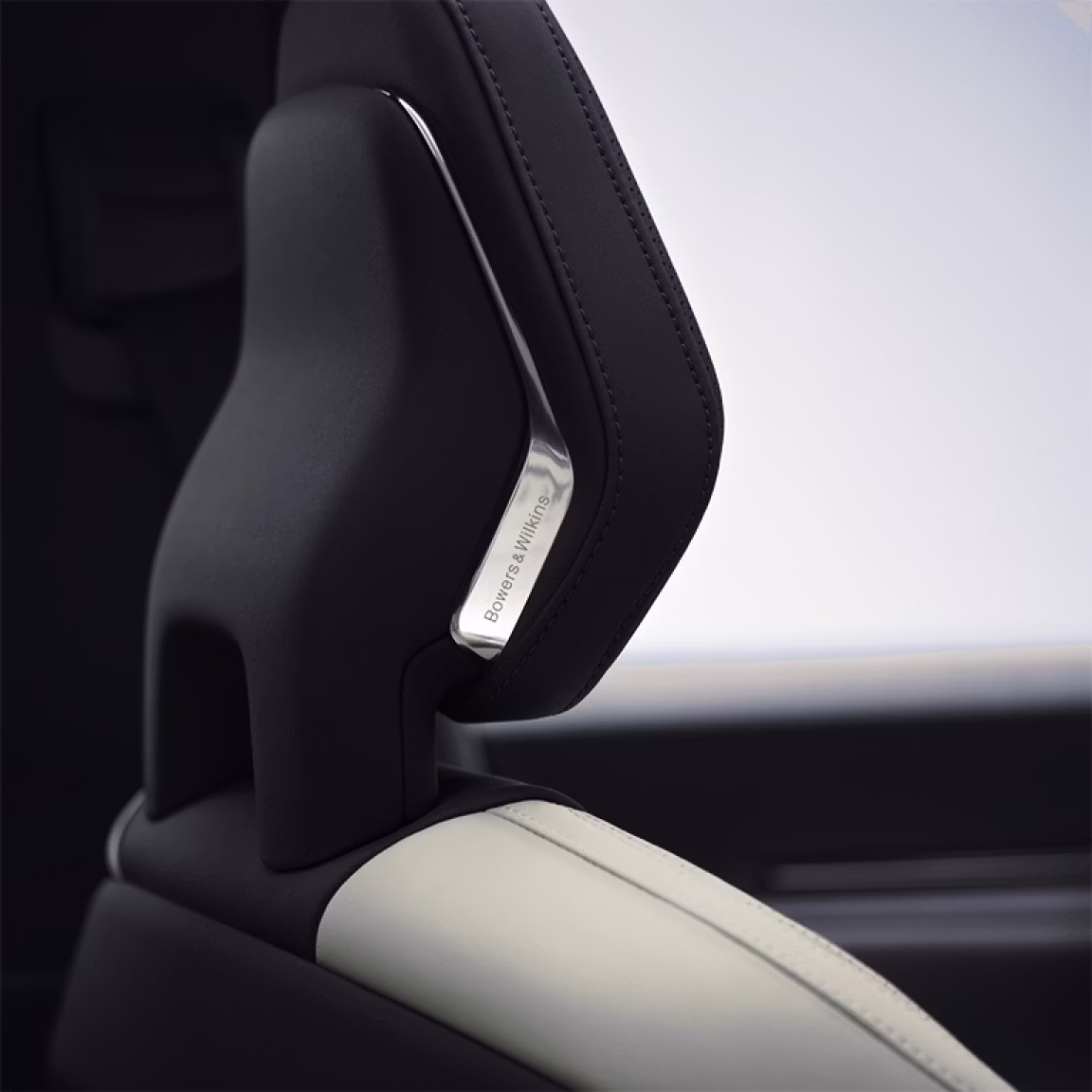 A close up view of Polestar 3’s front seat headrest with the Bowers & Wilkins metal logo.