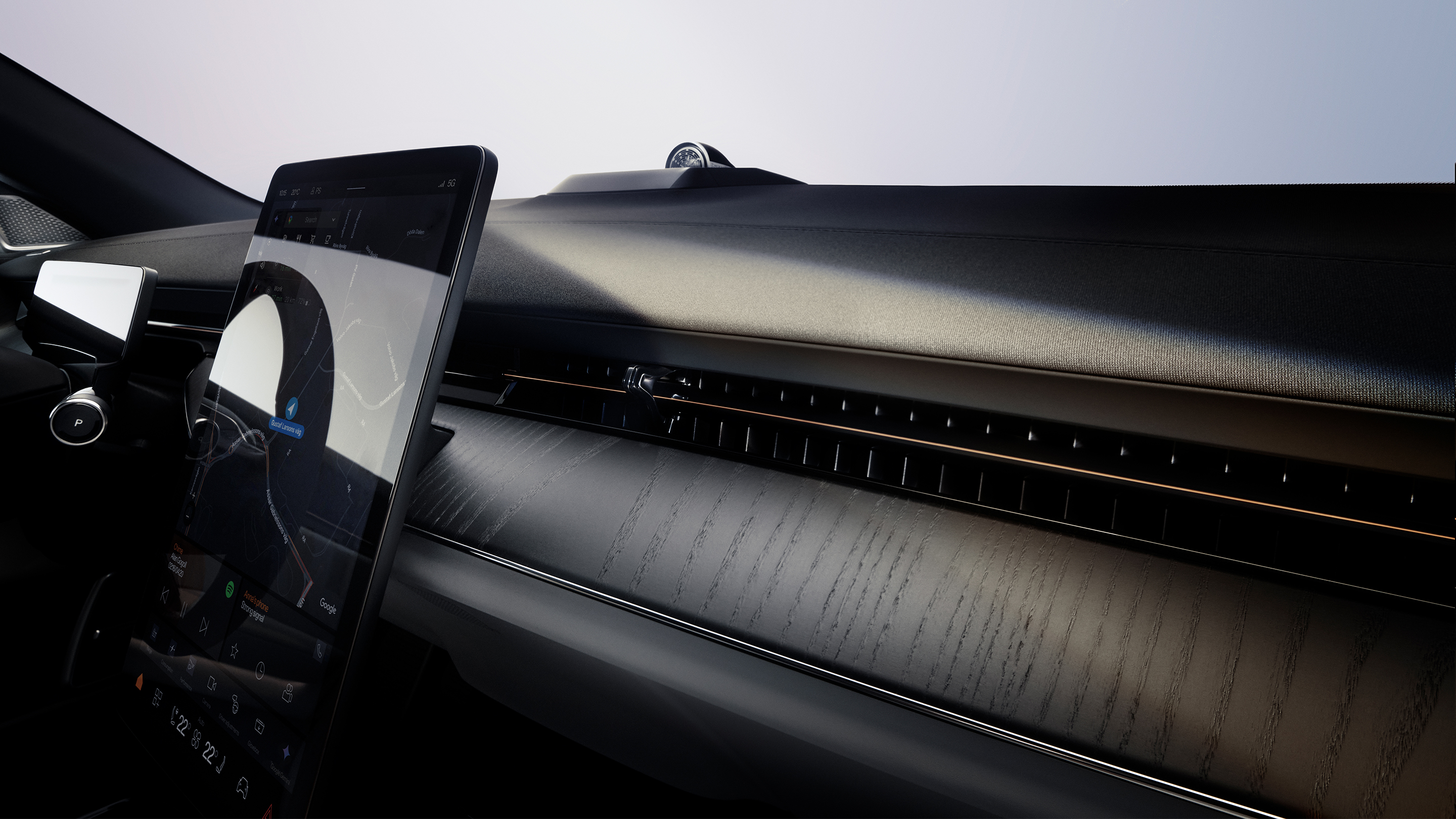 A panned view of Polestar 3’s dashboard in Charcoal colour, centre display, and windscreen.