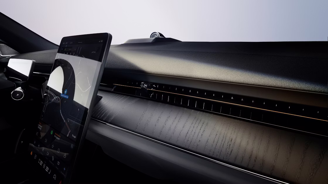 A panned view of Polestar 3’s dashboard in Charcoal colour, centre display, and windscreen.