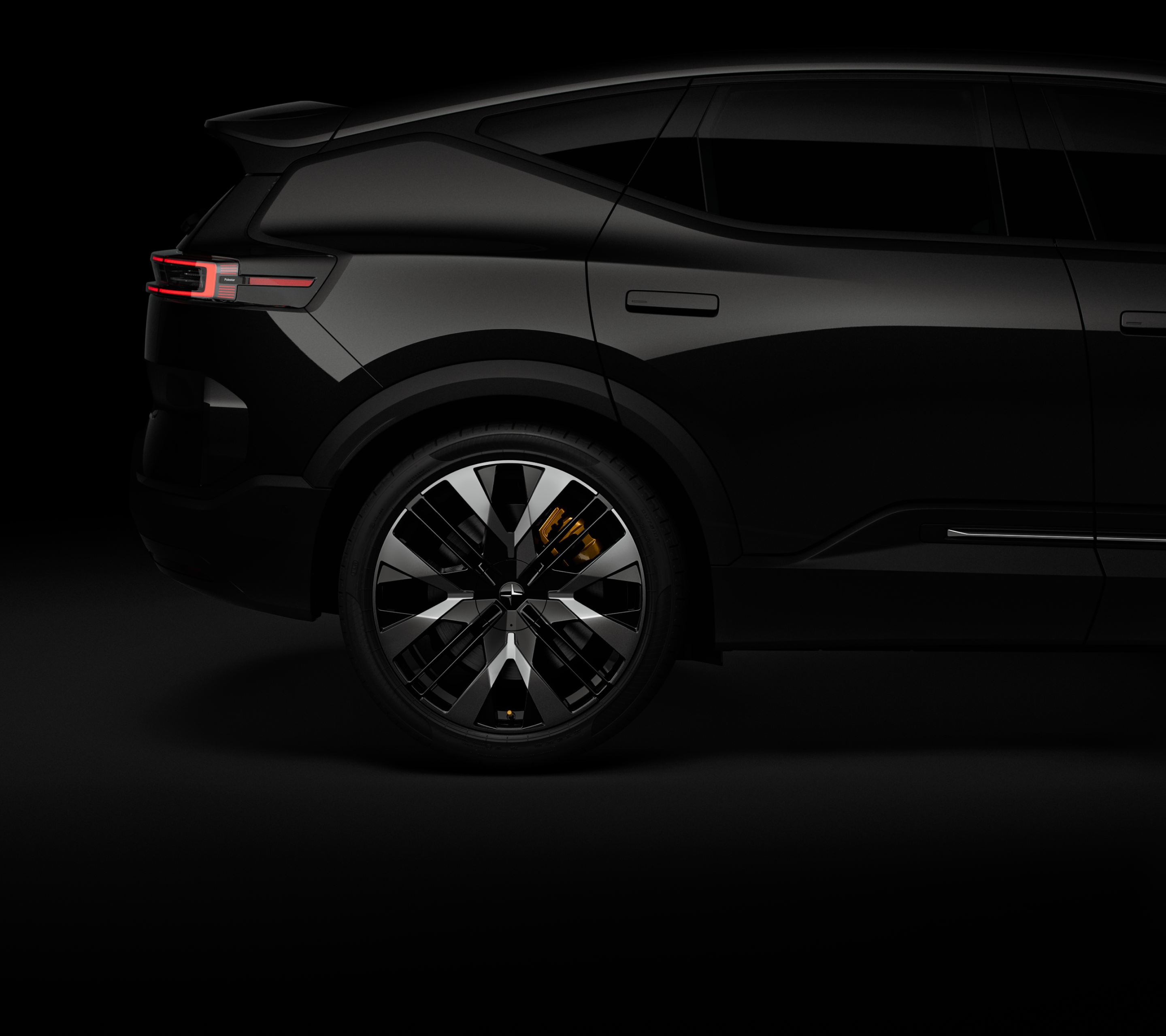 Partial side view of a black Polestar 3 against a black backdrop with gold brake calipers.