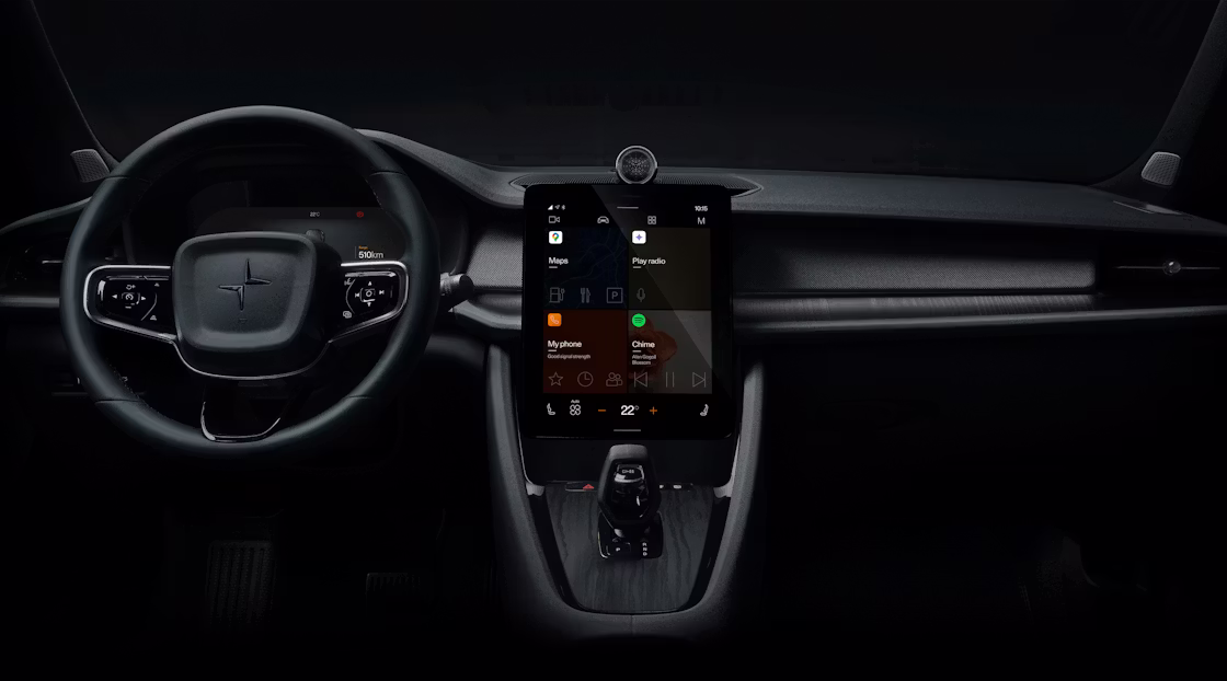 Polestar 2’s dashboard area with the steering wheel and centre display against a dark background.