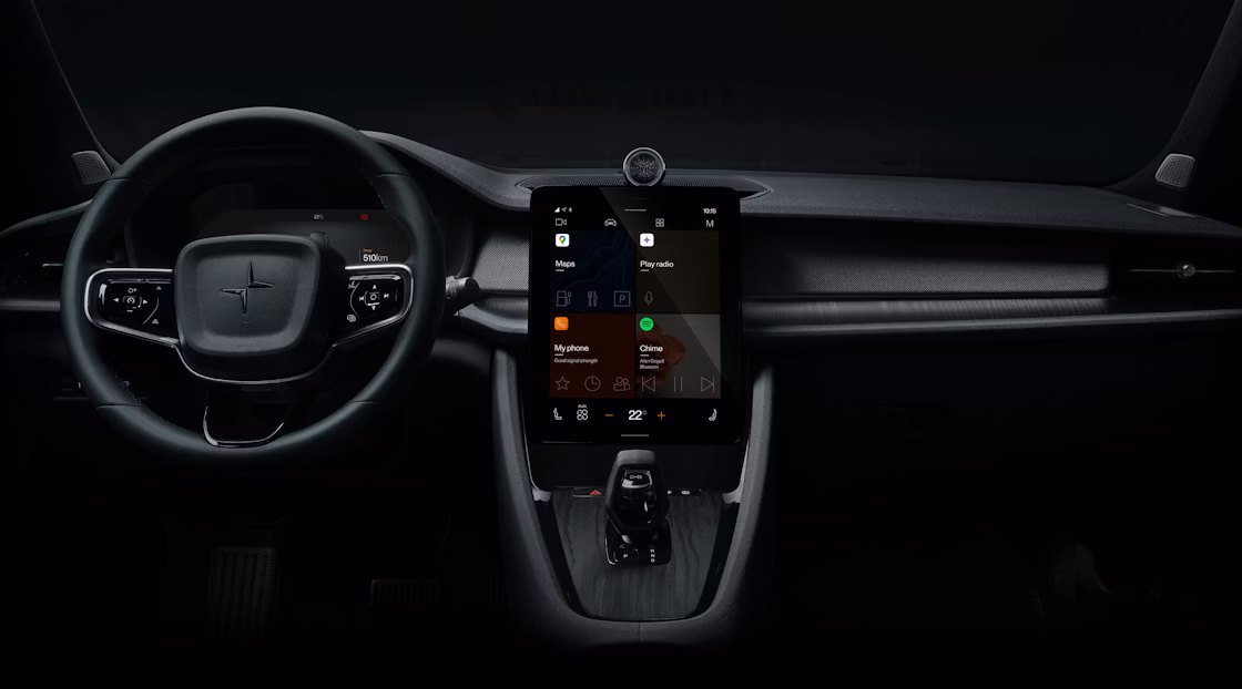 Polestar 2’s dashboard area with the steering wheel and centre display against a dark background.