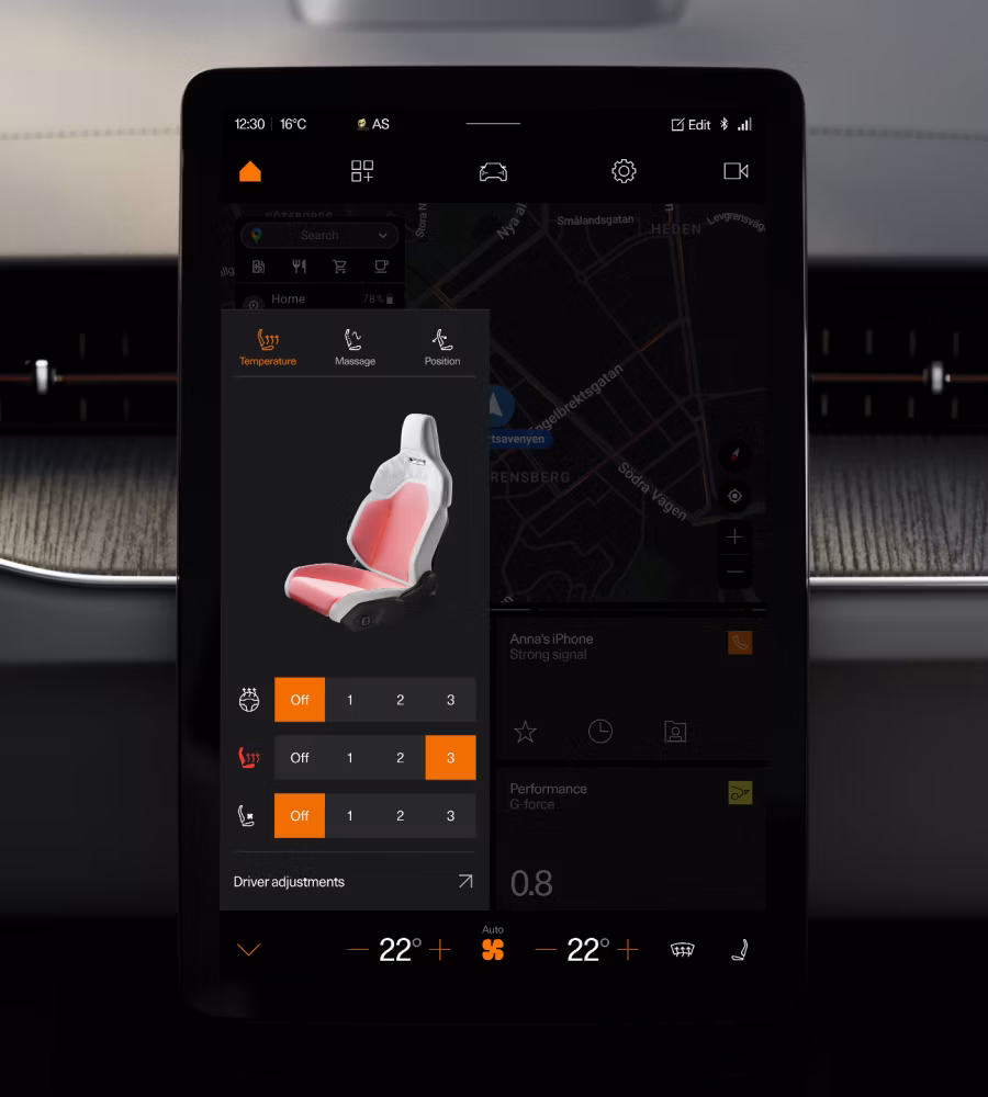 Car touchscreen showing seat temperature and massage controls over a map